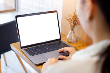 computer mockup blank screen.hand woman work using laptop with white background for advertising,contact business search information on desk at coffee shop.marketing and creative design