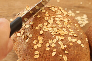 two fresh farmer's breads with a knife