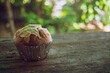 Soft focus, silhouette, brown banana soft cake topped with brown almonds in silver paper Put on the old wooden floor Looks very appetizing With colored bokeh background