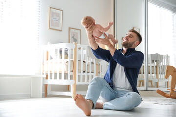 Poster - Father with his newborn son at home