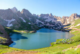 Fototapeta Góry - a glacial lake in mountains, winter season, cold weather and blue sky, snowy mountains
