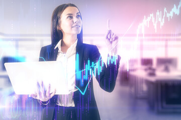 Poster - Businesswoman with laptop drawing glowing stock chart