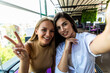 © F8  \ Suport Ukraine - Two young beautiful women sitting in urban cafe and making selfie.