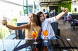 © F8  \ Suport Ukraine - Young two women sitting at cafe and taking selfie