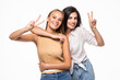 © F8  \ Suport Ukraine - Two playful girls standing together and showing peace gestures while looking at the camera over white background