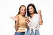 © F8  \ Suport Ukraine - Two shocked young female friends looking at mobile phone against white background
