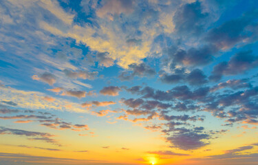 Wall Mural - cloudy sunset landscape with sun