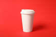 © New Africa - Takeaway paper coffee cup on red background