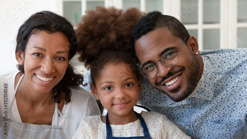 Fotomural Head shot close up portrait of smiling african ethnicity parents posing for phot