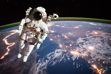Wall Mural - astronaut walking in space with earth background. elements of this image furnished by nasa
