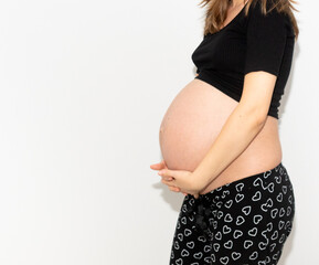 Wall Mural - Pregnant woman model touching her pregnancy belly abdomen, isolated on white background.