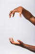 © denis_vermenko - African american black man hand hanging something blank isolated on a white background. Close-up.