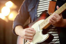 Close Up Hand Young Man Playing Electric Guitar At Recording Studio Rehearsal Base. Rock Music Band.