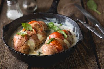 Chicken fillet baked with mozzarella tomatoes and basil