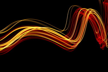 Wall Mural - Long exposure photograph of neon red and gold colour in an abstract swirl, parallel lines pattern against a black background. Light painting photography.