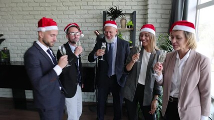 Wall Mural - Business people are celebrating holiday in modern office drinking champagne and having fun in coworking. Merry Christmas and Happy New Year 2021.