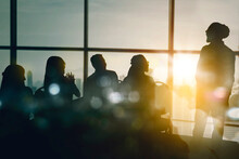 Silhouette Of Business People Doing Presentation
