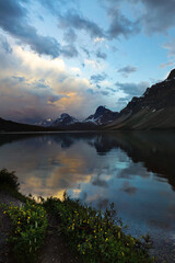 Wall Mural - Cloud and storm reflections over Bow Lake in Alberta,, Canada along the famous Icefield Parkway. Calm yet moody scene, tranquil isolation