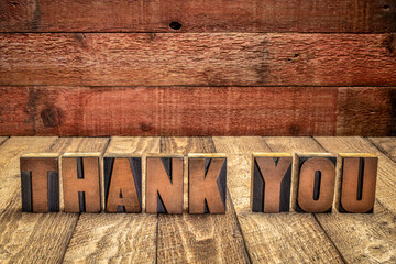 thank you - word abstract in vintage letterpress wood type blocks against grunge barn wood background