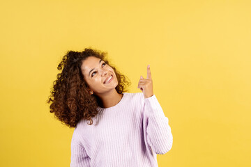 Wall Mural - Young afro american woman on yellow copy space background