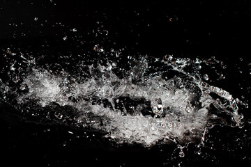  Splash of clear water on black isolated background.