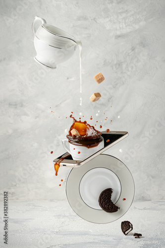 Splashing coffee with milk, cane sugar and cookie. Coffee break. Creative food photography concept.