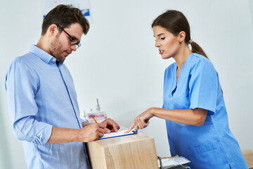 Patient signing documents in dental clinic