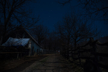 Wall Mural - Full moon over quiet village at night. Beautiful night landscape of old town street with lights