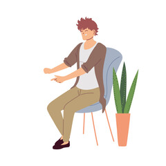 Sticker - smiling young man sitting on a chair next to a pot