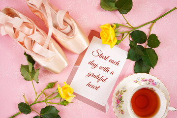 Wall Mural - Pointe Ballet Shoes Aesthetic theme desktop workspace background on stylish pink textured background. Top view blog hero header flat lay. Start Each Day with a Grateful Heart text.