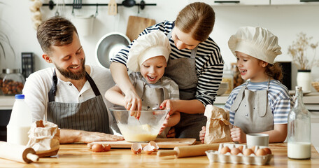 Wall Mural - Positive family preparing pastry together.