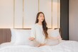© siraphol - Portrait beautiful young asian woman meditation on bed