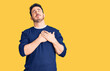 © Krakenimages.com - Young hispanic man wearing casual clothes smiling with hands on chest with closed eyes and grateful gesture on face. health concept.