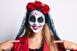 © Krakenimages.com - Woman wearing day of the dead costume over white looking confident with smile on face, pointing oneself with fingers proud and happy.