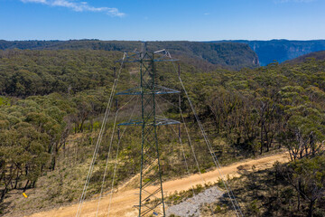 Aerial view of power lines running through a forest in regional Australia