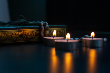 Quran in the mosque - open for prayers The black background of the Muslims around the world placed on a wooden board Quran in the mosque - open for prayers