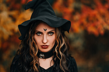 Close-up face of woman wearing witch hat on head for halloween