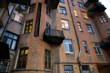 Poster - residential stone old house in the city in the evening