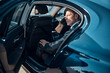 © Svitlana - Handsome mature businessman sitting in comfortable car