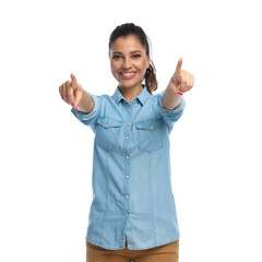 Wall Mural - happy smart casual woman pointing forward with both hands, smiling