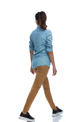Wall Mural - side rear view of smart casual woman walking