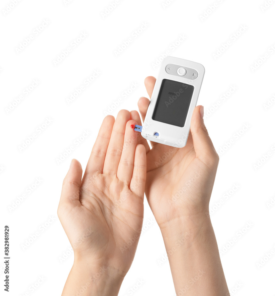 Female hands with glucometer on white background. Diabetes concept