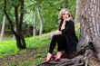 © ako-photography - young, beautiful girl sitting in the woods on the roots of a tree