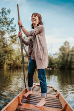 A Beautiful Young Woman Punts On A Boat In A River In Oxford. Punting, Tourist, River, Boat. 