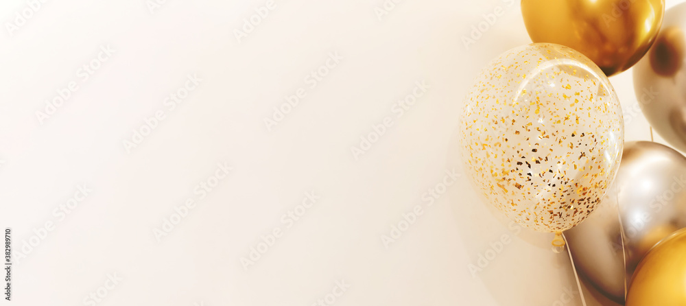 Golden and Silver colour balloons on white background with copy space ...