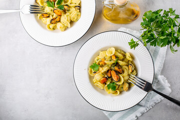 Poster - Italian pasta orecchiette with mussels and potato and garlic sauce. Top view copy space.