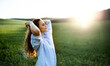 Portrait of young teenager girl outdoors in nature on meadow at sunset.