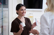 © Yakobchuk Olena - Smiling young cosmetologist recommending anti-aging cosmetics for lady