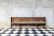 front view of old single wooden bench on checkered pattern marble tiles floor with brick and cement wall background in church