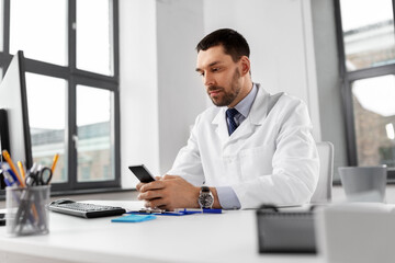 Sticker - healthcare, medicine and people concept - male doctor with smartphone at hospital